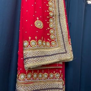 Carrot Red Saree with heavy work on it.